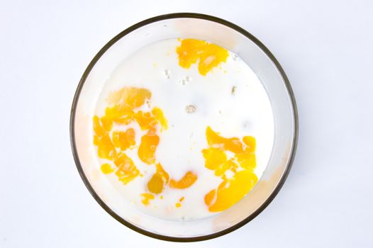 Mix of Raw eggs and mikk in glass bowl.