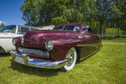 Mercury Coupe, custom 1949 model. The car is in amazingly good condition and perfect in the paint. The image is shot at dawn at the farm in Halden, Norway.