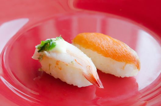 Sushi with Shrimps and  sushi with salmon on red dish