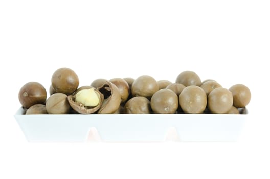 macadamia in  white bowl  over  white background