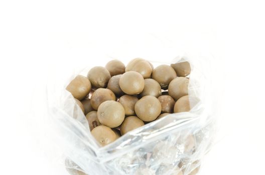 macadamia in plastic bag on white background