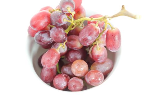 top view grape in white bowl over white background