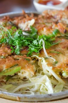 close up of crispy omelet and vegetable on plate