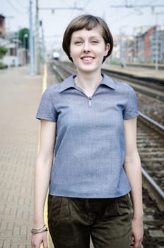 young beautiful hipster woman walking in a railway station