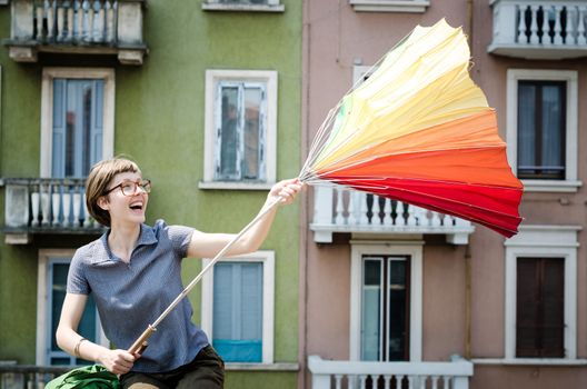young beautiful hipster woman with colorful umbrella in the city