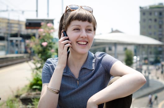 young beautiful hipster woman on the phone in the city