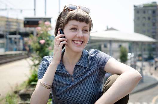 young beautiful hipster woman on the phone in the city