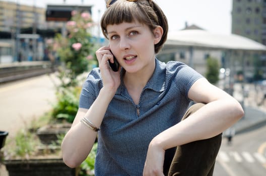 young beautiful hipster woman on the phone in the city
