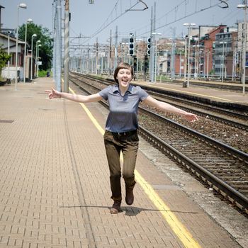 young beautiful hipster woman happy running in the station