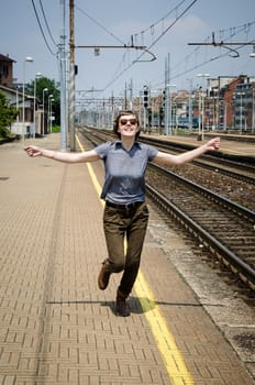 young beautiful hipster woman happy running in the station