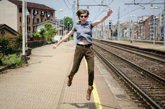 young beautiful hipster woman jumping in the station