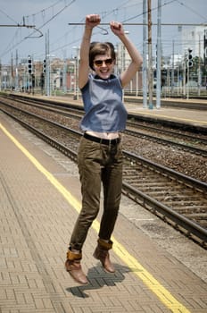young beautiful hipster woman jumping in the station