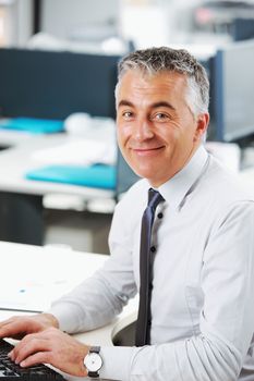 Handsome businessman sitting at his desk