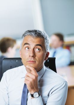 Mature businessman looking up at copy space
