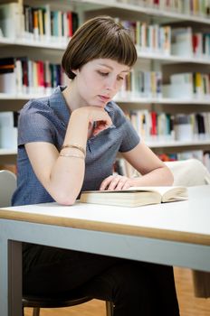young beautiful hipster woman in library