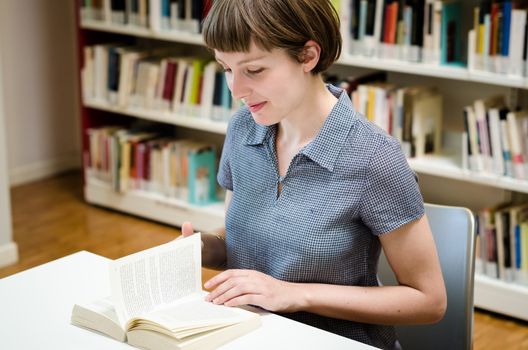 young beautiful hipster woman in library