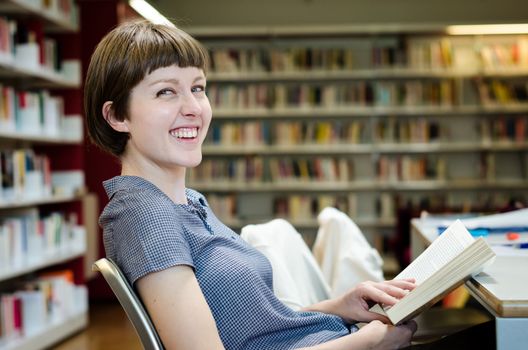 young beautiful hipster woman in library