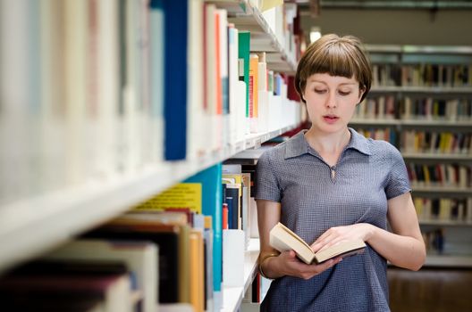 young beautiful hipster woman in library
