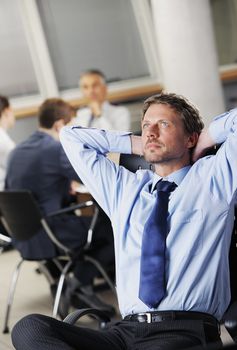 Portrait of a relaxed Businessman with meeting in the background