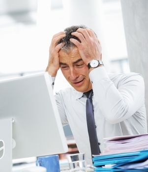 Businessman under stress, fatigue and headache, he kept his hands behind his head