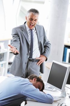 Tired business man sleeping at work. In the background is angry boss shouting