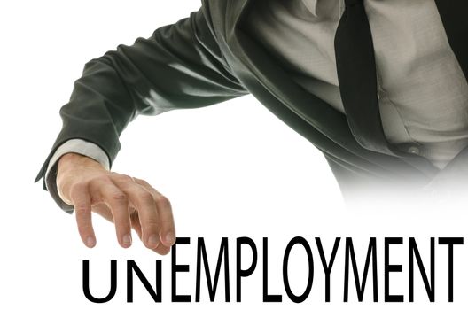 Male hand pushing away letters UN of the word Unemployment.