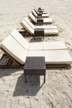 Rows of several lounge chairs on the beach