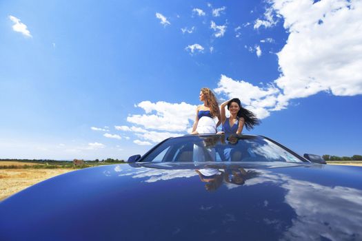 women dance in car