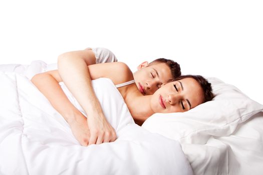 Young couple happily sleeping in white bed, isolated.