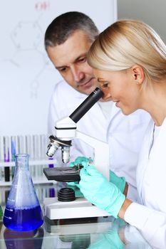 two scientist in chemical lab conducting experiments