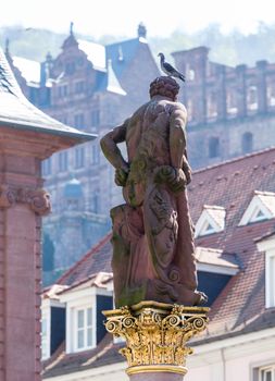 Statue of Hercules erected in 1703 in Market Square by Rathaus in old town city of Heidelberg Germany
