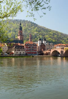 Medieval bridge leading into old town of Heidelberg Germany from riverbank of River Neckar
