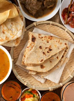 Indian bread, Chapati flatbread, roti canai, dal, curry, teh tarik or pulled tea, acar. Famous indian food.