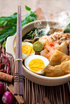 Prawn mee, prawn noodles. Famous Malaysian food spicy fresh cooked har mee in clay pot with hot steam.