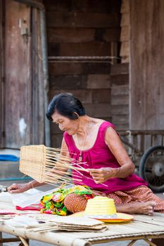 SUKHOTHAI, THAILAND - MAY 4: Unidentified mature woman is selling Thai traditional fan on May 4, 2013 at Rim Yom 2437 night market, Sukhothai, Thailand.