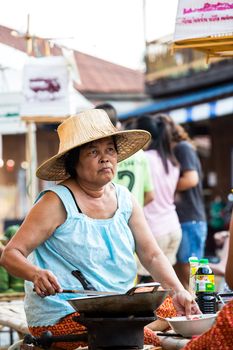SUKHOTHAI, THAILAND - MAY 4: Unidentified mature woman is selling Thai traditional snack on May 4, 2013 at Rim Yom 2437 night market, Sukhothai, Thailand.