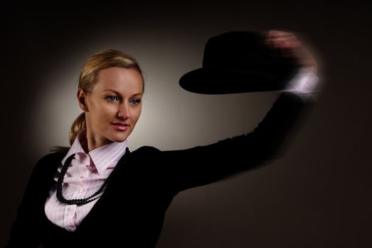 Dynamic studio photo of the woman moving her hat