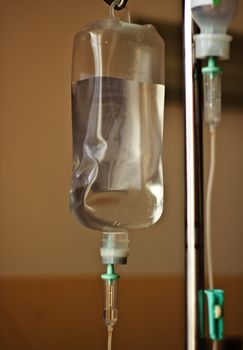 IV bag hanging on a metal pole in the room