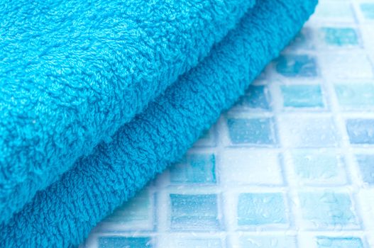 Blue Bath Towels on Blue Bathroom Tiles