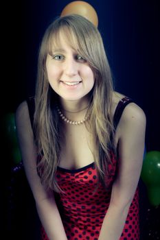 portrait of a smiling girl on a dark background