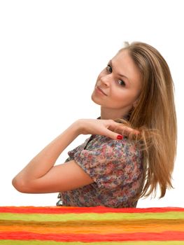 The beautiful girl with a long fair hair looks back through a shoulder