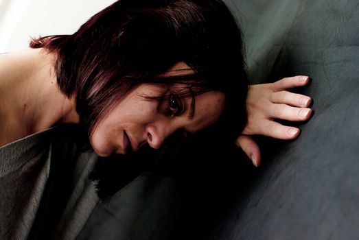 conceptual portrait of stressed abused young woman 