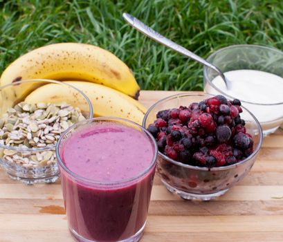 healthy berries juice smootie on wooden board