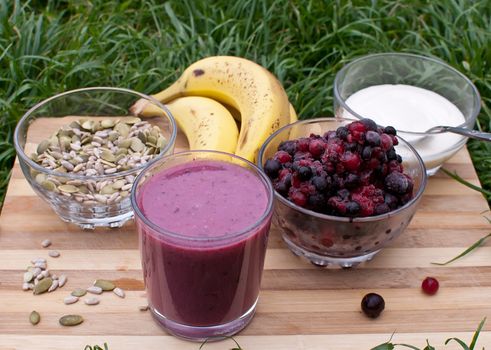 healthy berries juice smootie on wooden board