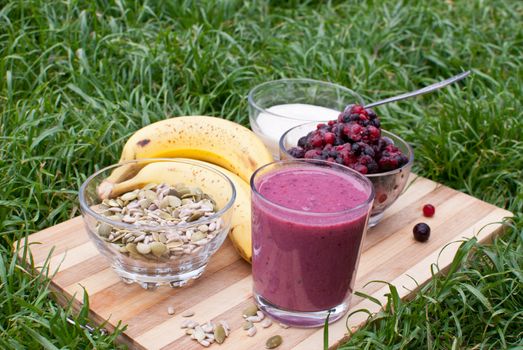 healthy berries juice smootie on wooden board