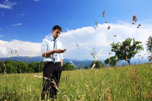 Young business man using a smart phone outdoors