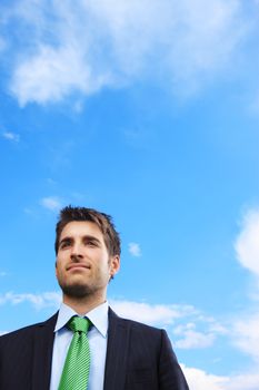 Portrait of a young business man against ble sky