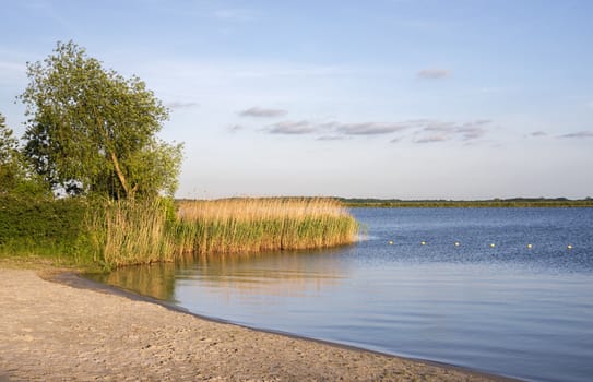 sunset in holland with beach and water