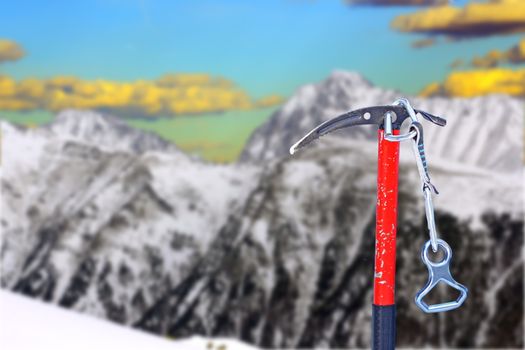 old ice axe for attempting to conquer the summit - austrian alps in the background