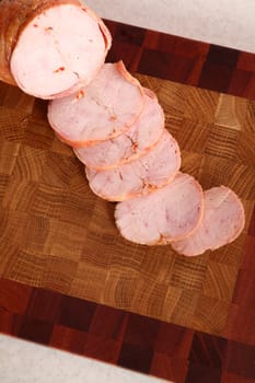 Ham slices on a wooden chopping board